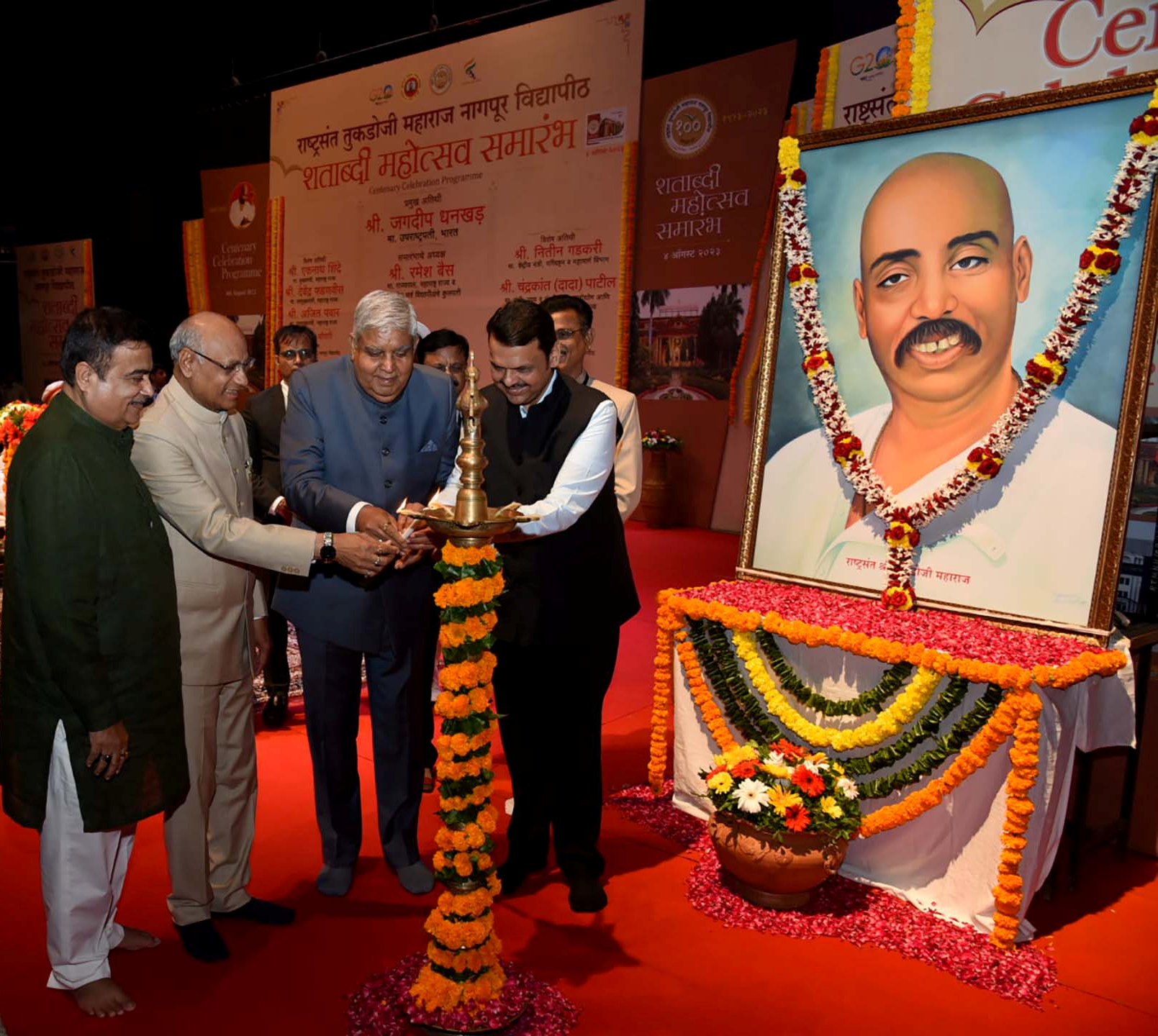 The Vice President, Shri Jagdeep Dhankhar lighting the lamp at the Centenary Celebrations of Rashtrasant Tukadoji Maharaj  Nagpur University in Nagpur, Maharashtra on August 4, 2023.
