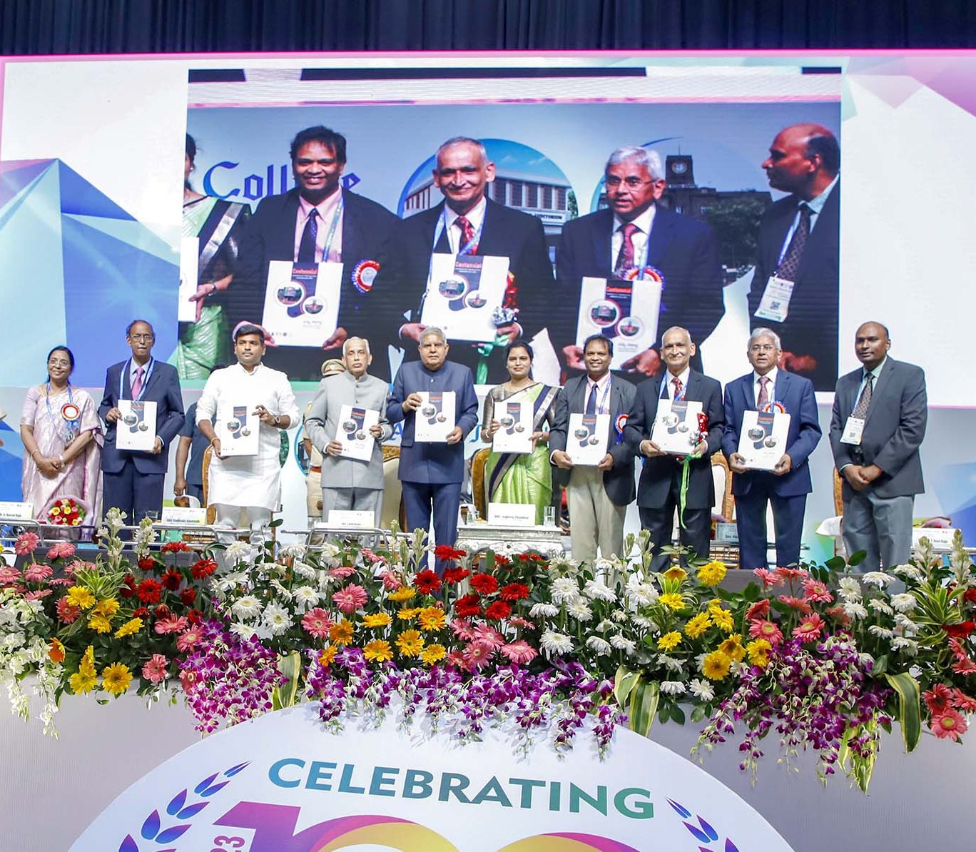 The Vice-President, Shri Jagdeep Dhankhar releasing First day Postal Cover and Centenary Coffee Table Book of Andhra Medical College, Visakhapatnam in Andhra Pradesh on October 28, 2023.