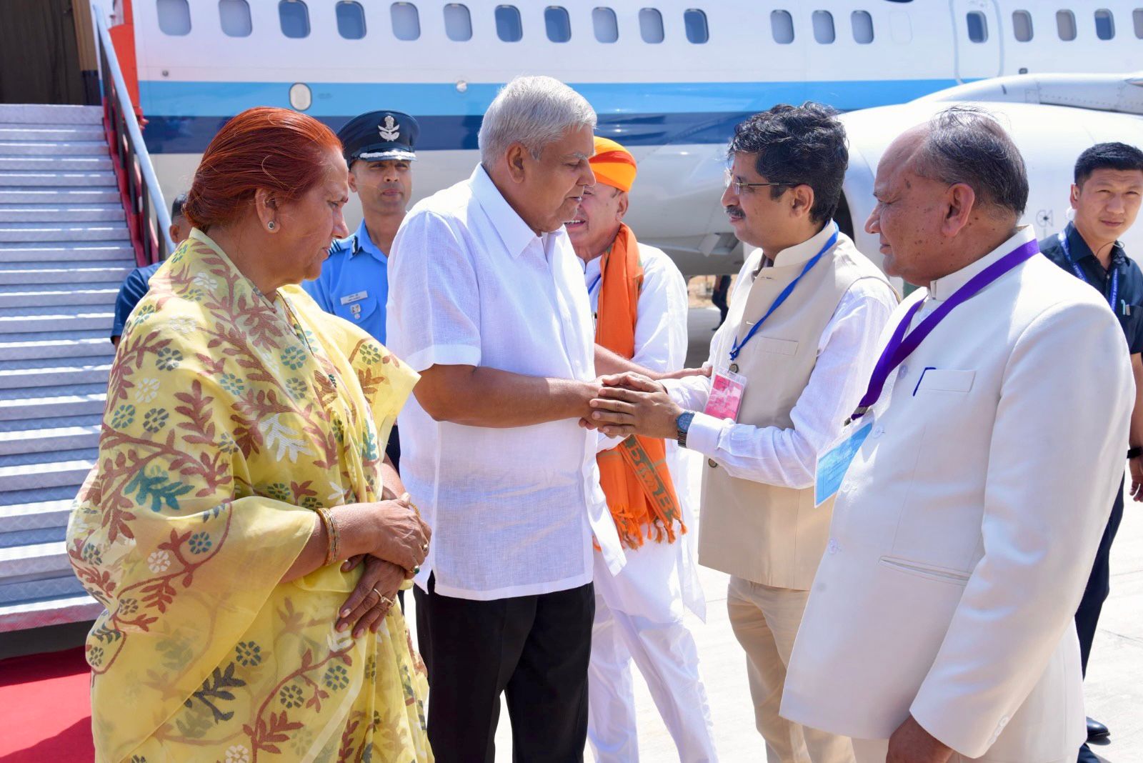  The Vice-President, Shri Jagdeep Dhankhar and Dr. Sudesh Dhankhar being welcomed by Shri Jogaram Patel, Minister, Government of Rajasthan and other dignitaries on their arrival in Jaisalmer, Rajasthan on June 13, 2024.