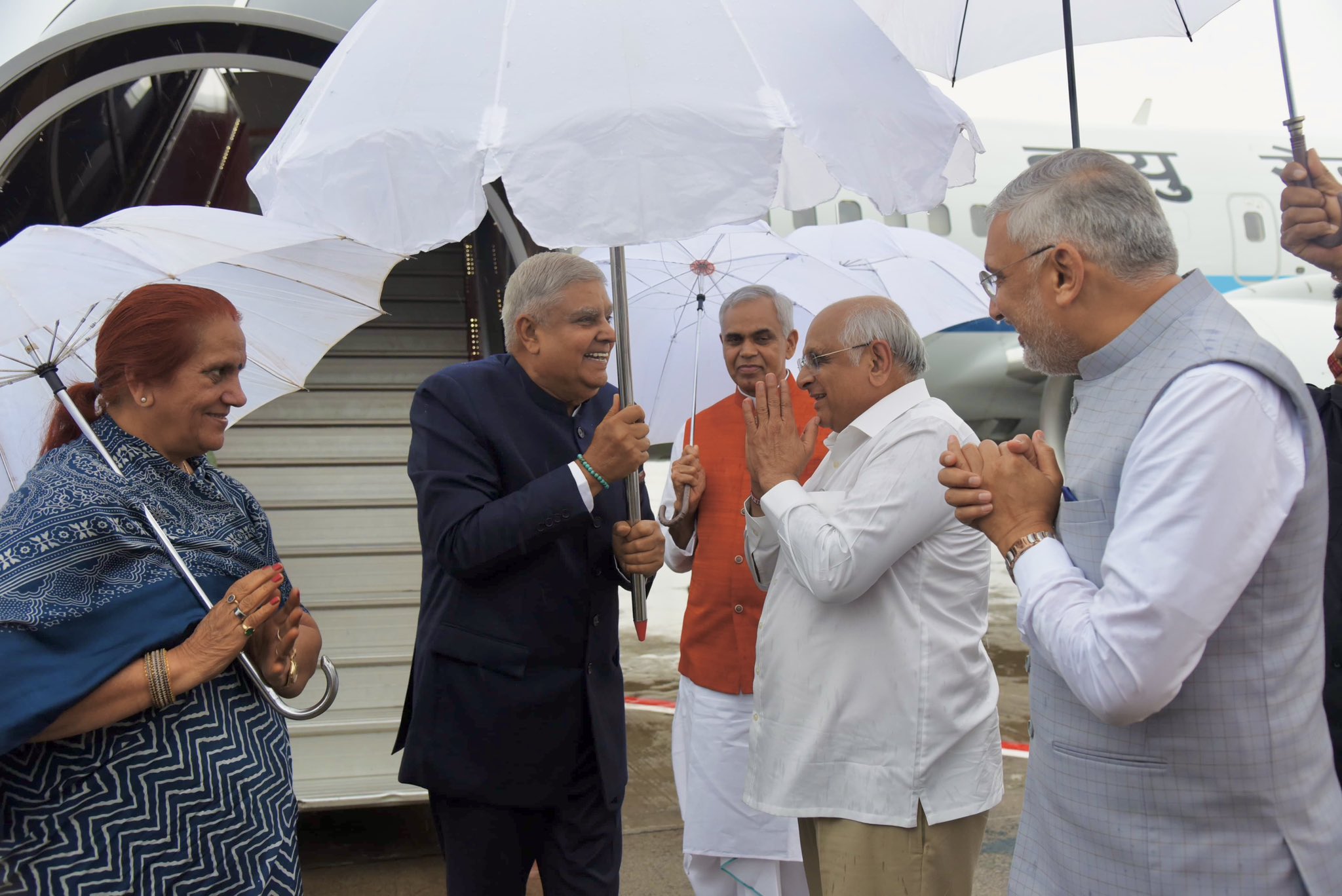 The Vice-President, Shri Jagdeep Dhankhar and Dr. Sudesh Dhankhar being welcomed by Shri Acharya Devvrat, Governor of Gujarat, Shri Bhupendra Patel, Chief Minister of Gujarat, Shri Jagdish Vishwakarma, Minister, Government of Gujarat and other dignitaries on their arrival in Ahmedabad, Gujarat on August 23, 2024.