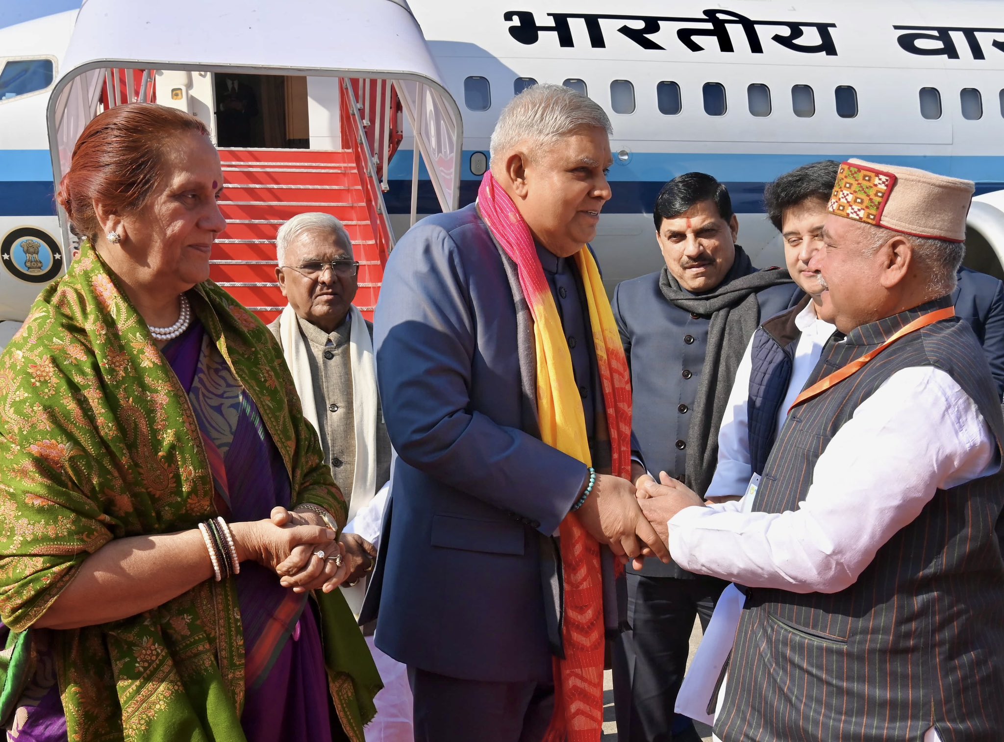 The Vice-President, Shri Jagdeep Dhankhar and Dr Sudesh Dhankhar being welcomed by Shri Mangubhai Patel, Governor of Madhya Pradesh, Dr. Mohan Yadav, Chief Minister of Madhya Pradesh, Shri Jyotiraditya Scindia, Minister of Communications, and Development of North Eastern Region, Shri Narendra Singh Tomar, Speaker, Madhya Pradesh Legislative Assembly and other dignitaries on their arrival in Gwalior, Madhya Pradesh on December 15, 2024.